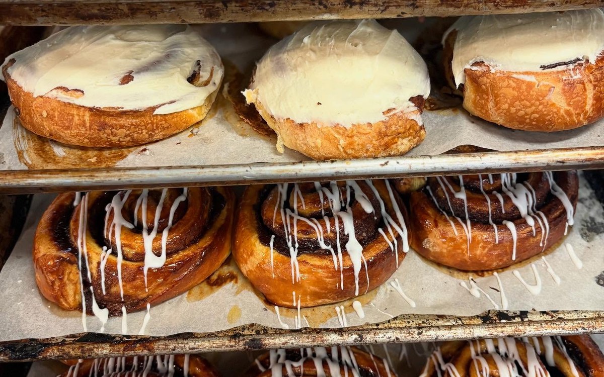 Tray of fresh cinnamon rolls and breakfast pastries
